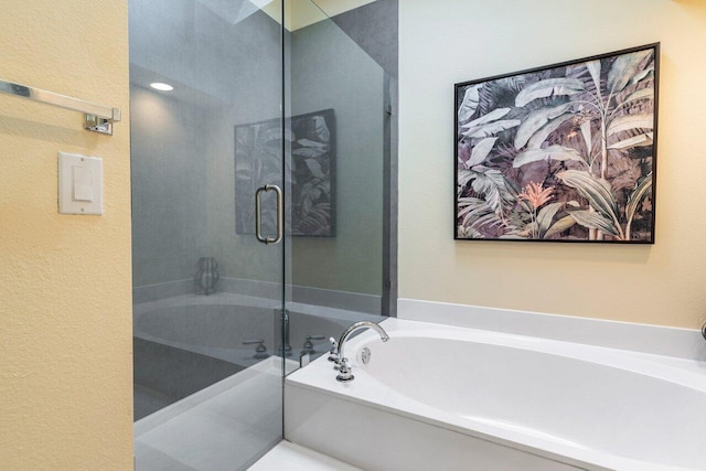 bathroom with a tub to relax in