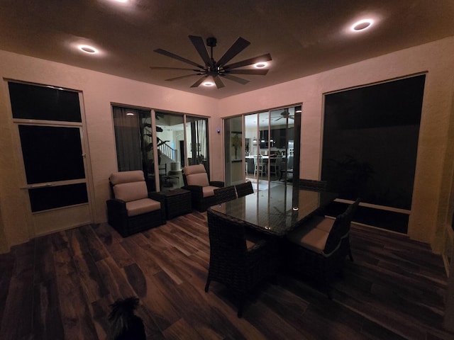 dining space with ceiling fan and dark wood-type flooring