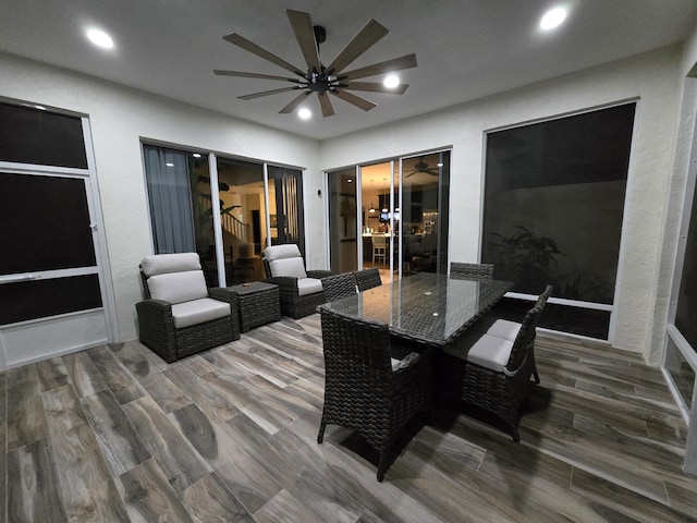 wooden terrace with ceiling fan and an outdoor living space