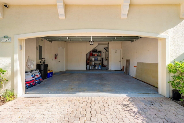 garage featuring a garage door opener and electric panel