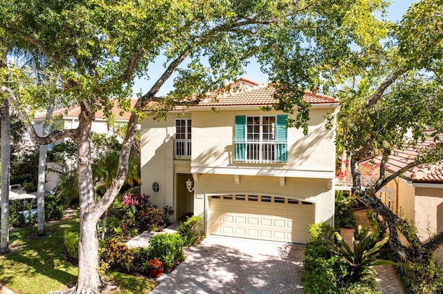 mediterranean / spanish-style house with a garage