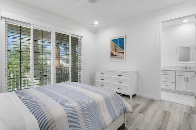 bedroom with crown molding, ceiling fan, sink, light hardwood / wood-style flooring, and ensuite bathroom