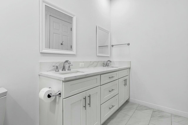 bathroom with toilet and vanity