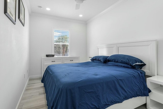 bedroom featuring ceiling fan, light hardwood / wood-style flooring, and crown molding