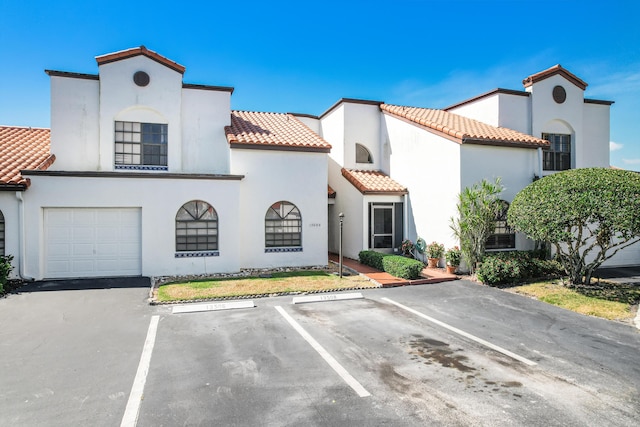 mediterranean / spanish home featuring a garage