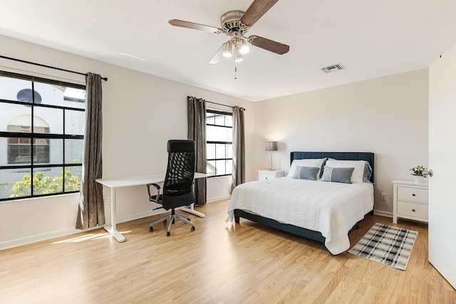 bedroom featuring light wood-style floors, visible vents, and multiple windows