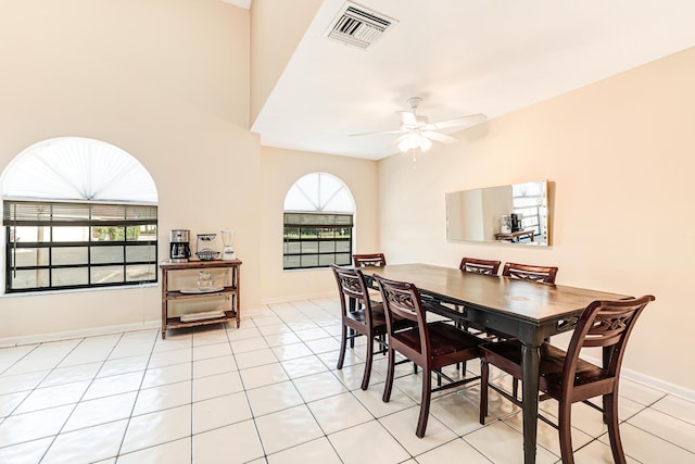 tiled dining area with ceiling fan