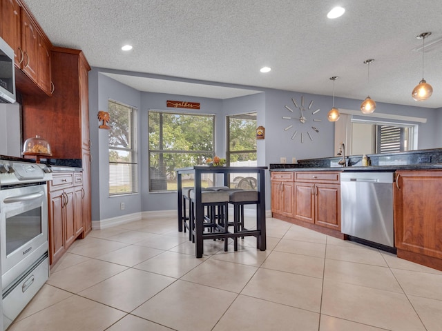 kitchen with dishwasher, electric stove, a textured ceiling, and decorative light fixtures