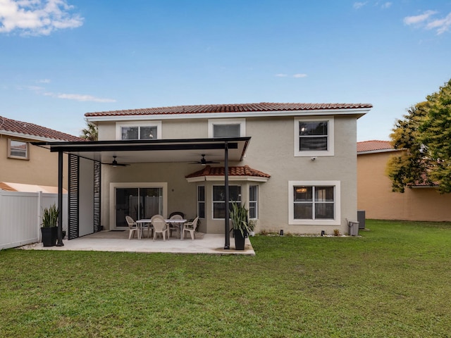 back of property featuring a lawn, ceiling fan, a patio area, and central AC