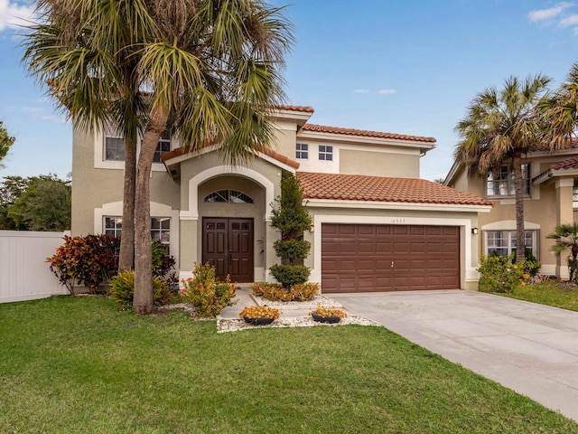 mediterranean / spanish house with a front yard and a garage