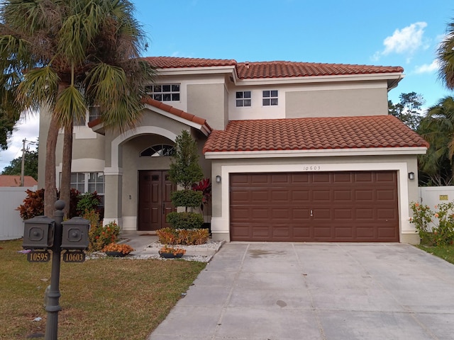 mediterranean / spanish home featuring a garage and a front yard