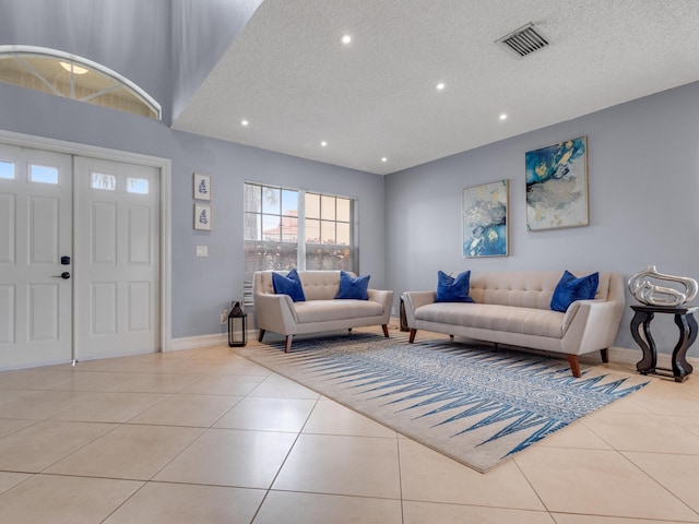 living room with light tile patterned floors and a textured ceiling