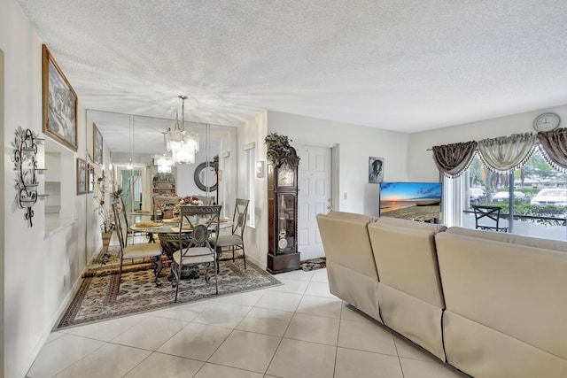 1102 Greenpine Blvd Unit A1, West Palm Beach, FL 33409 - living room with a chandelier, a textured ceiling, baseboards, and light tile patterned flooring