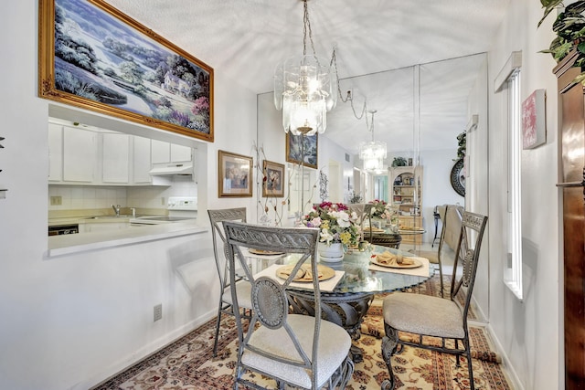 dining space with sink and an inviting chandelier