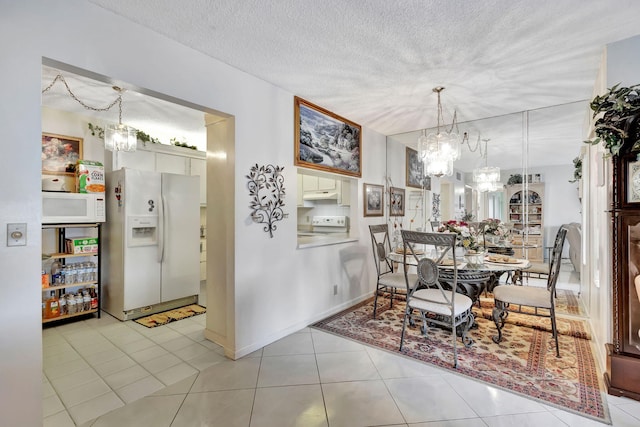 tiled dining space with a textured ceiling and a notable chandelier