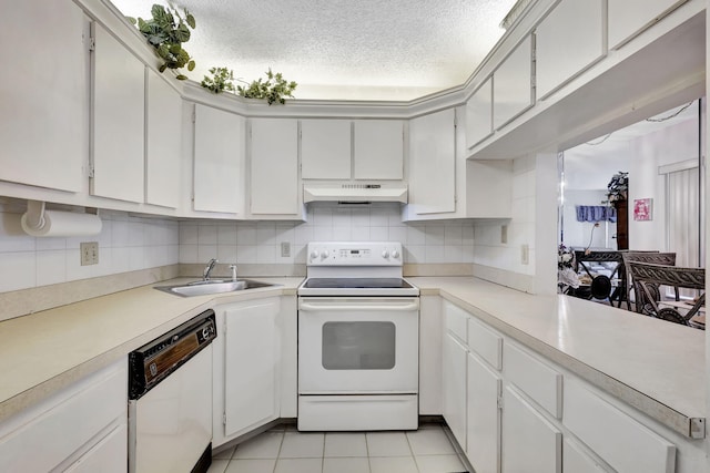 kitchen with light tile patterned floors, white appliances, white cabinetry, and sink