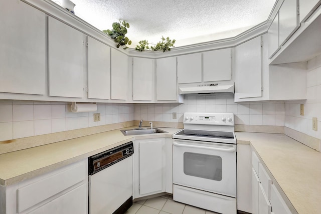 kitchen with white cabinets, light tile patterned floors, white appliances, and sink