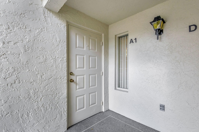 1102 Greenpine Blvd Unit A1, West Palm Beach, FL 33409 - property entrance with stucco siding