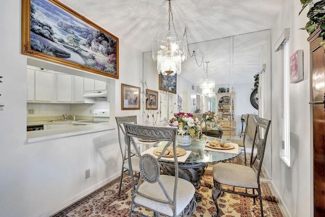 1102 Greenpine Blvd Unit A1, West Palm Beach, FL 33409 - dining area featuring a chandelier and baseboards