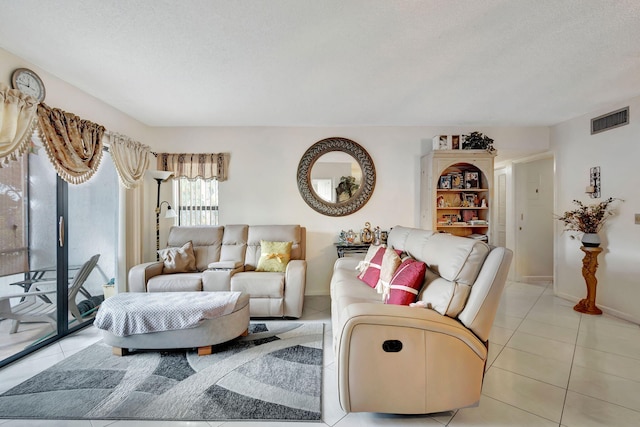 living room with light tile patterned floors and a textured ceiling