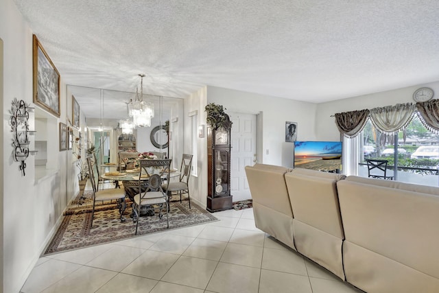 living room with light tile patterned floors, a textured ceiling, and a notable chandelier