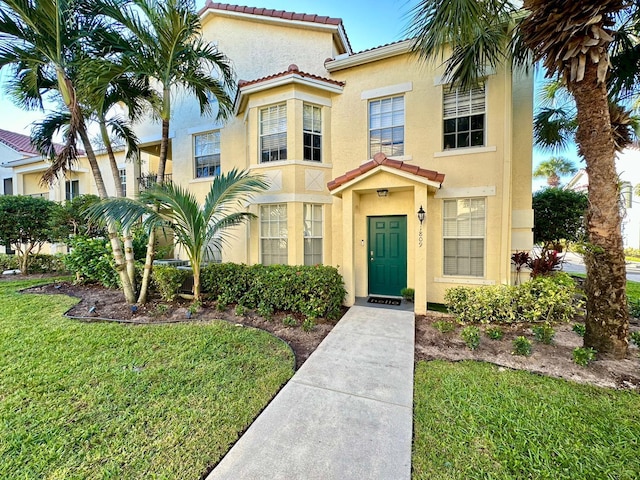 mediterranean / spanish-style house with a front yard