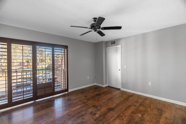 spare room with visible vents, a ceiling fan, a textured ceiling, wood finished floors, and baseboards