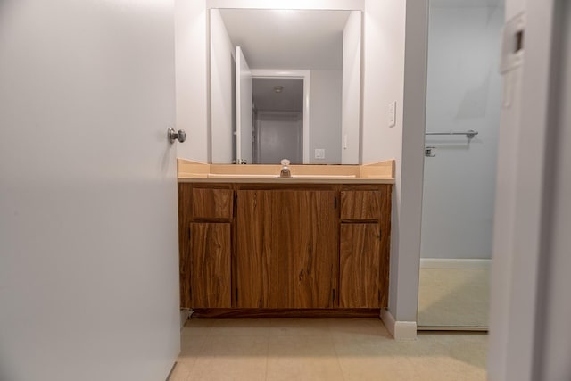 bathroom featuring vanity, tile patterned floors, and baseboards