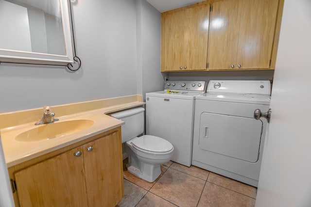 half bathroom featuring tile patterned floors, washer and dryer, toilet, and vanity