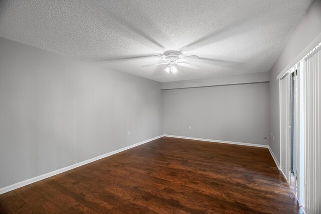 hall with dark hardwood / wood-style flooring and a textured ceiling