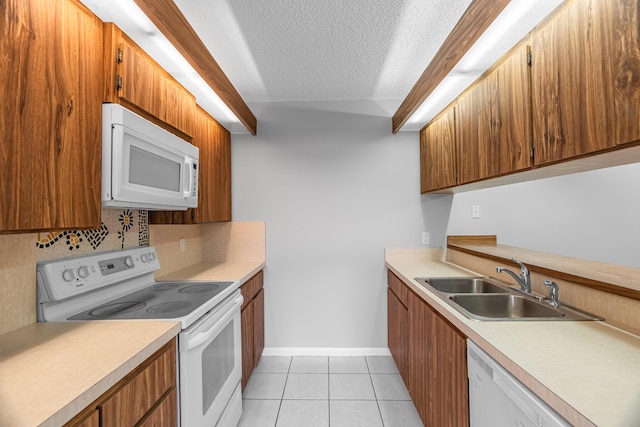 kitchen featuring white appliances, light tile patterned floors, light countertops, and a textured ceiling