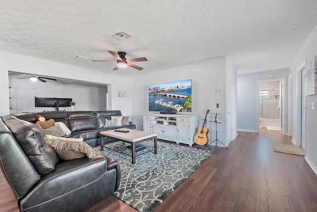 living room with dark hardwood / wood-style floors and a textured ceiling