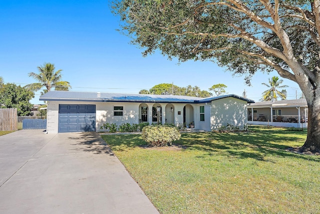 ranch-style home with a garage and a front lawn