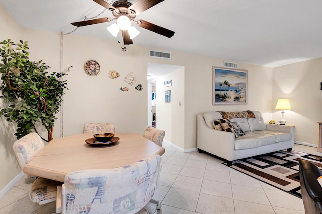 tiled dining space with ceiling fan