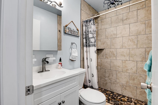 bathroom with a shower with shower curtain, vanity, and toilet