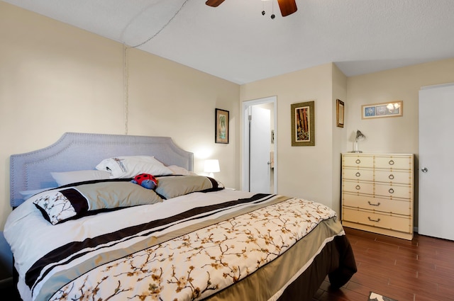 bedroom with ceiling fan and dark wood-type flooring