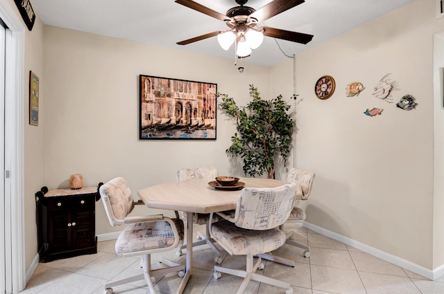 tiled dining room featuring ceiling fan