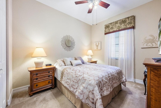 bedroom with ceiling fan and light colored carpet