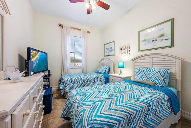 bedroom with ceiling fan and dark carpet