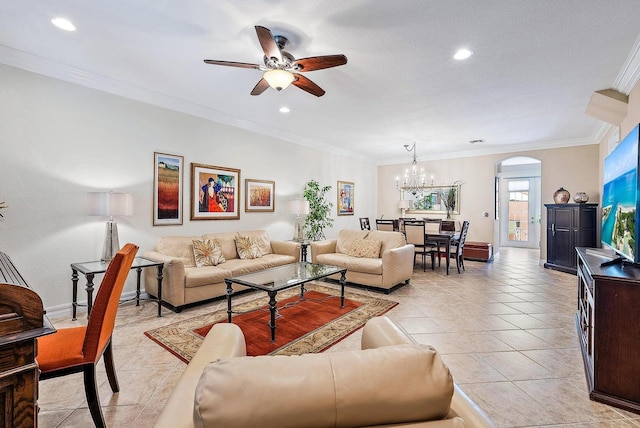 tiled living room with ceiling fan with notable chandelier and ornamental molding