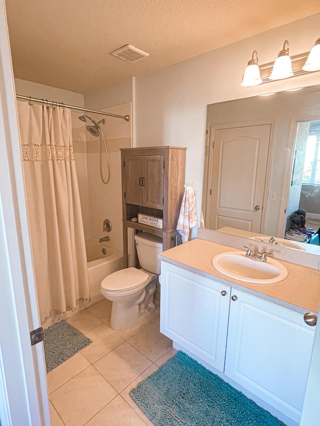 full bathroom featuring vanity, tile patterned flooring, toilet, a textured ceiling, and shower / tub combo