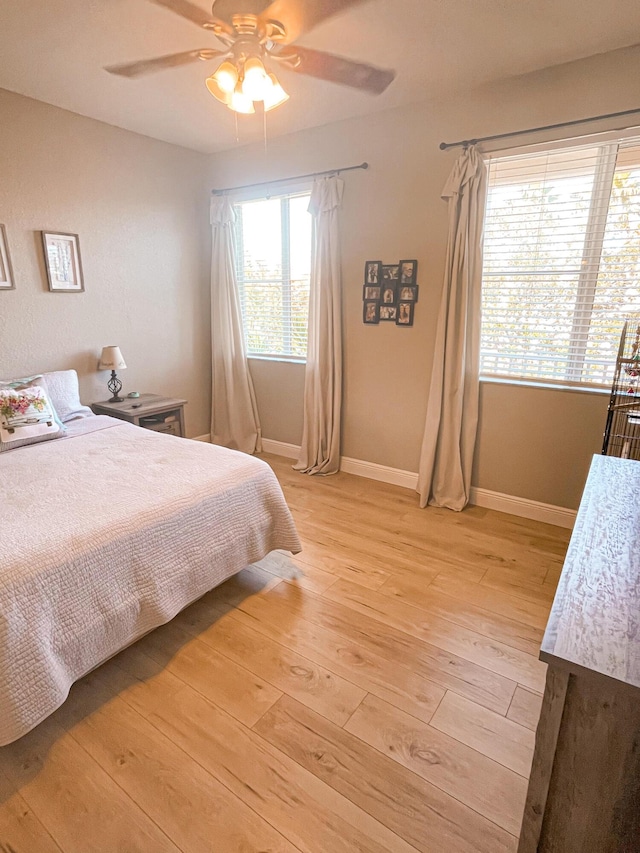 bedroom with ceiling fan and light wood-type flooring