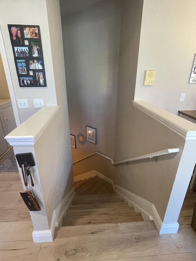 stairway with hardwood / wood-style flooring