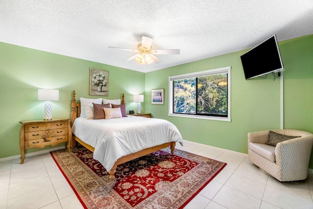 bedroom featuring a textured ceiling, ceiling fan, and light tile patterned flooring