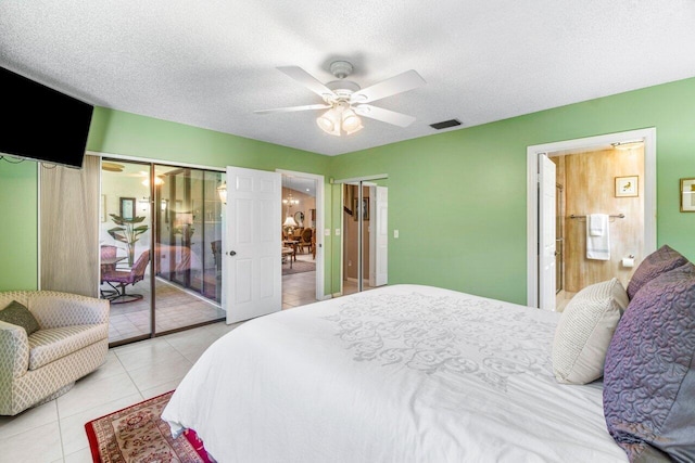 tiled bedroom featuring ceiling fan and a textured ceiling