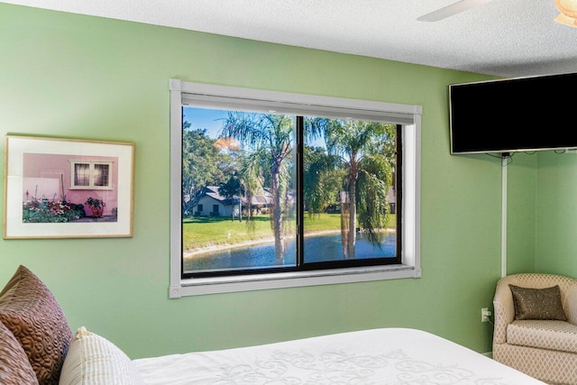 bedroom featuring ceiling fan and a textured ceiling