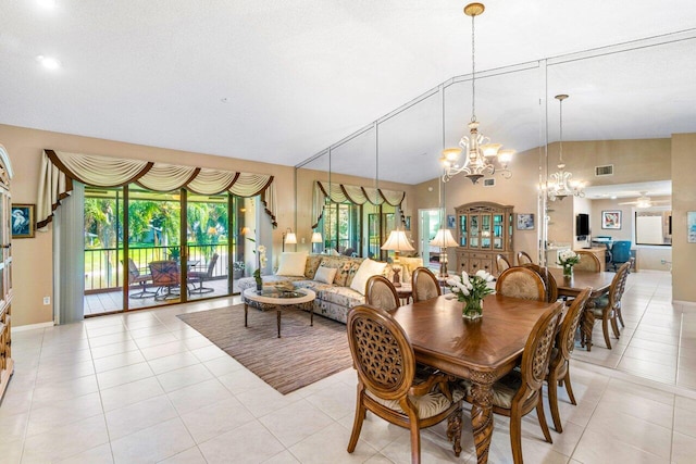 dining space with vaulted ceiling, a notable chandelier, and light tile patterned flooring