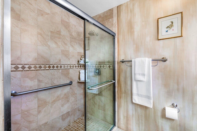 bathroom with a shower with shower door