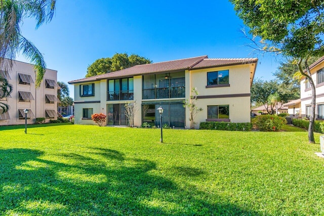 rear view of house featuring a yard