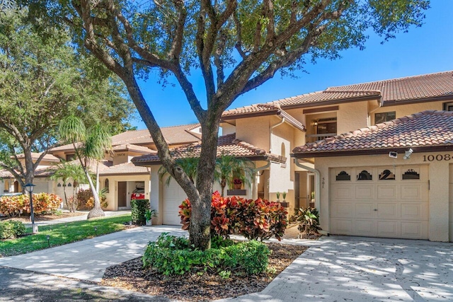 mediterranean / spanish home featuring a garage